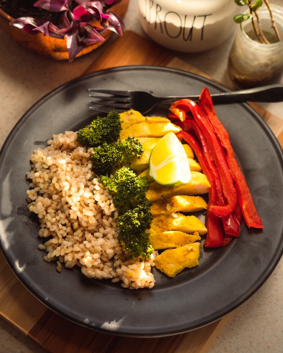 fried rice and green broccoli on blue ceramic plate